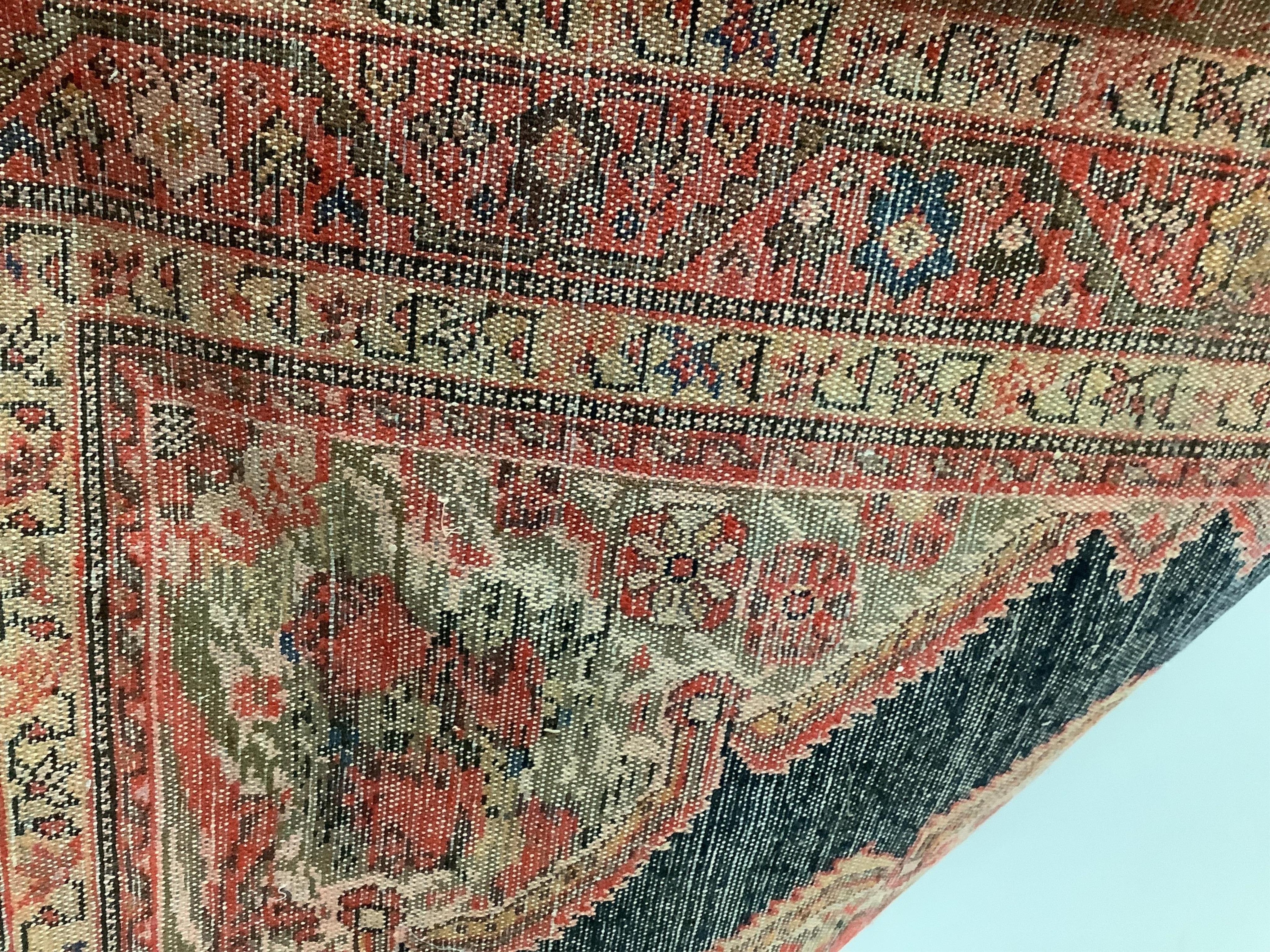 A North West Persian red ground rug, 186 x 120cm. Condition - faded with some wear